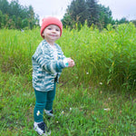 Load image into Gallery viewer, toddler walking through grassy field wearing red wool alpaca beanie, melange sweater and green cotton leggings
