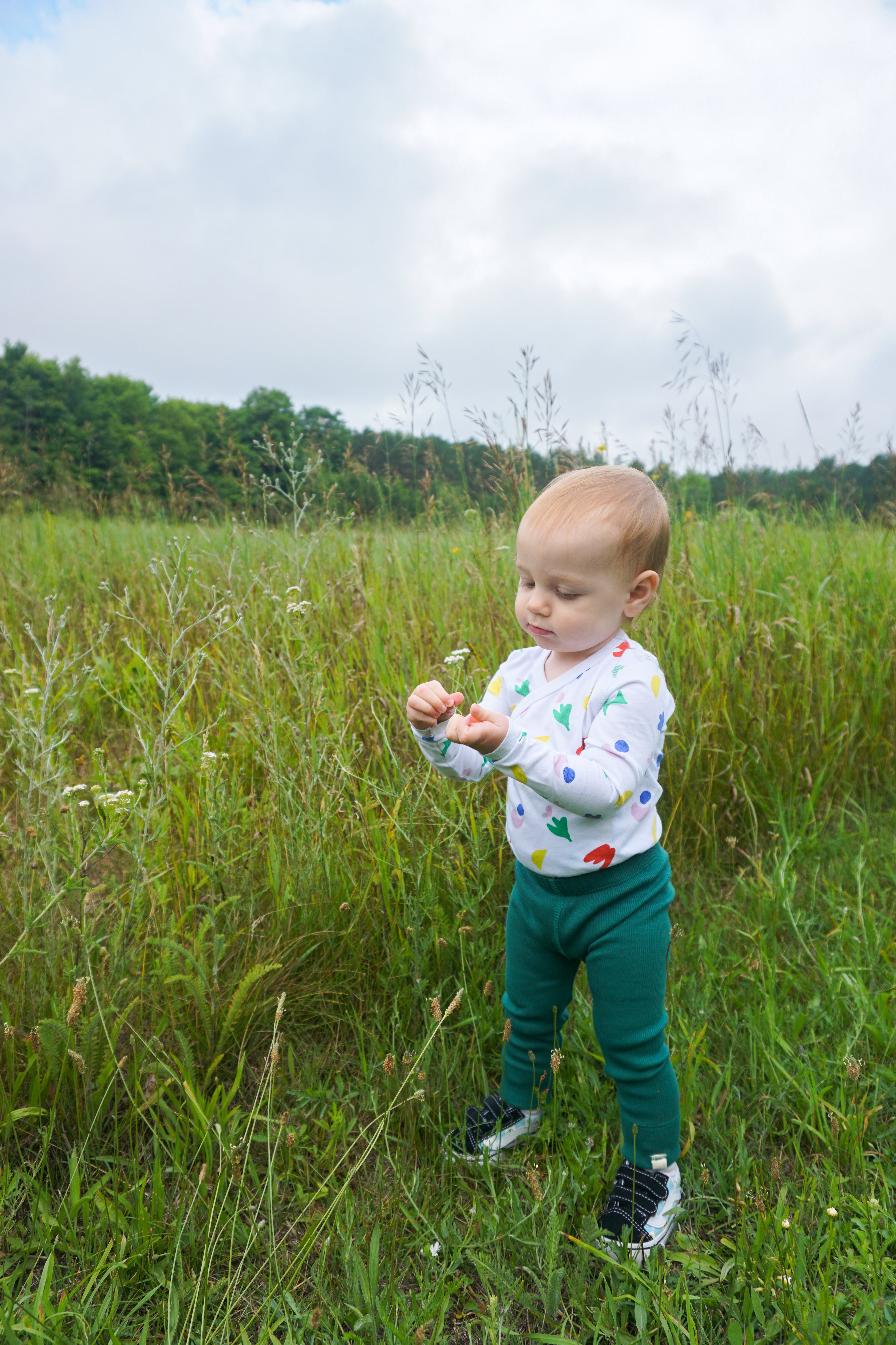 toddler wearing printed onesie and leggings