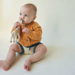 Load image into Gallery viewer,  toddler sitting wearing yellow 2-Texture Raglan Sleeve Cardigan with giraffe toy
