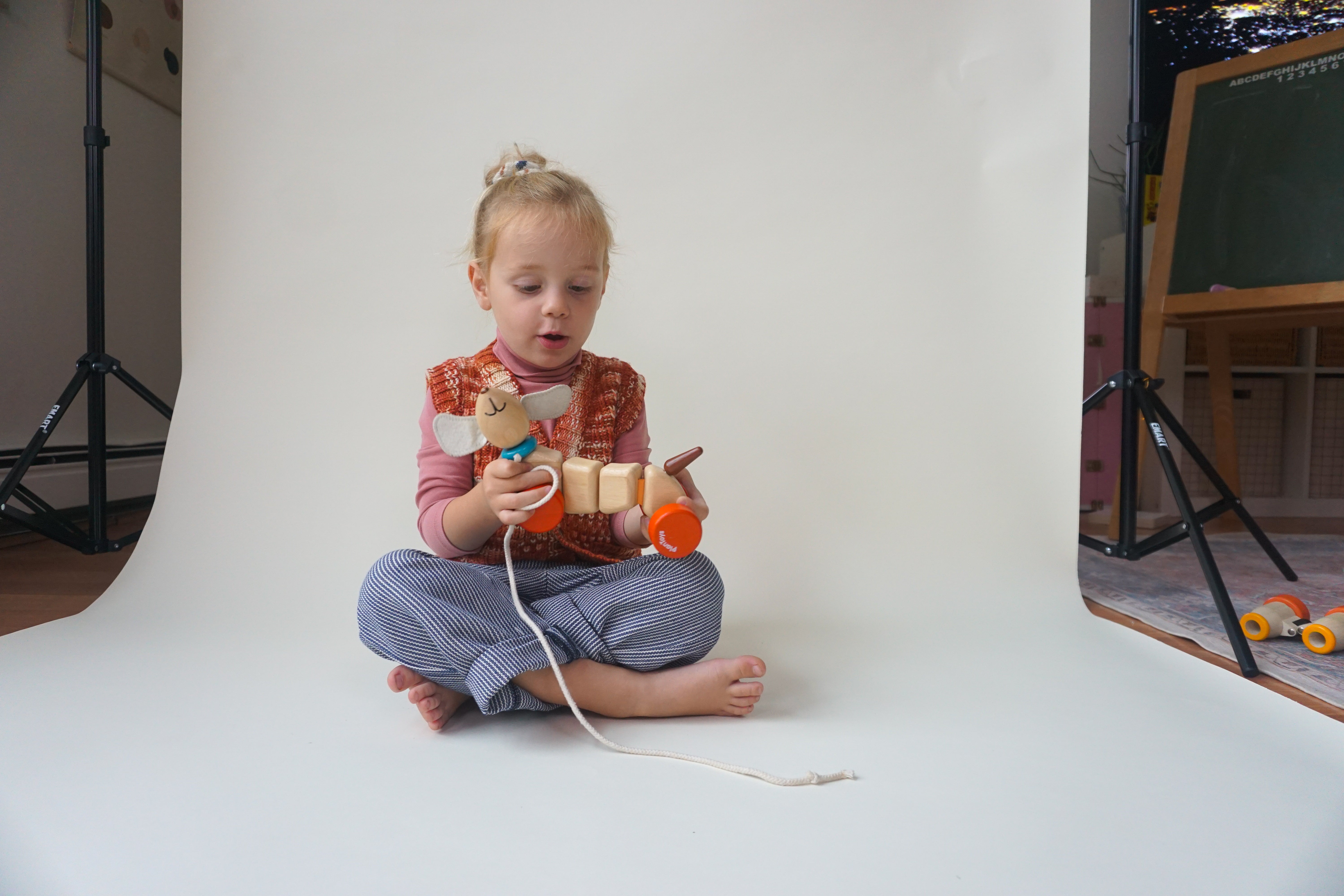 toddler wearing red wool vest and navy cotton stripe pants