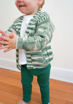 Load image into Gallery viewer, Clapping baby wearing green and marbled v-neck sweater and green leggings
