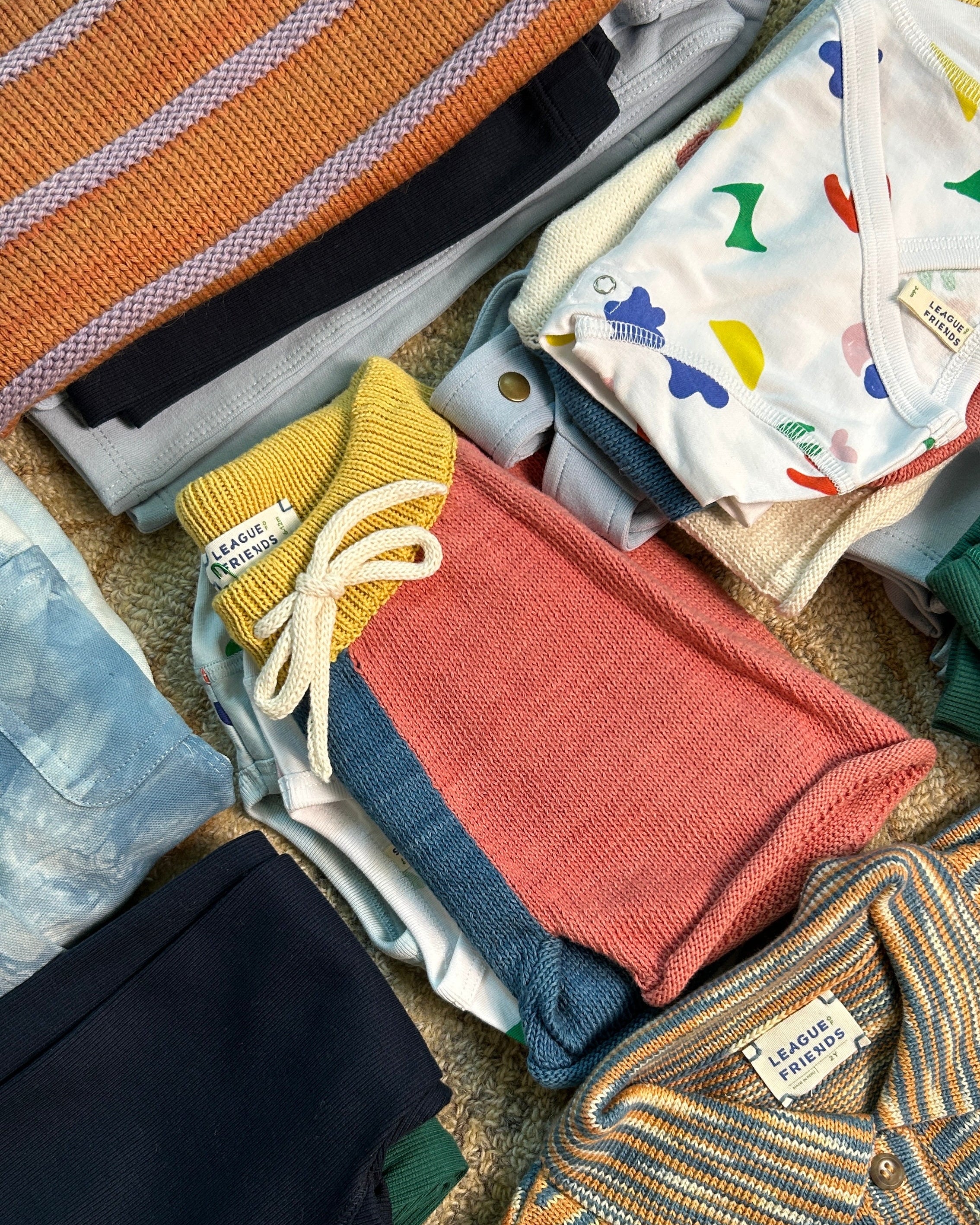 toddler clothing folded in piles
