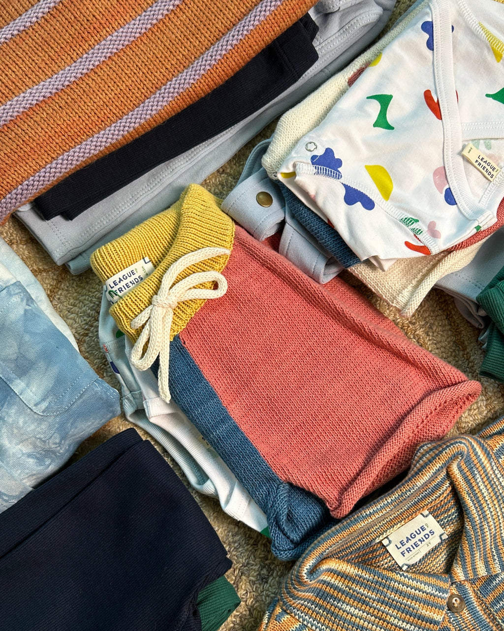 toddler clothing folded in piles