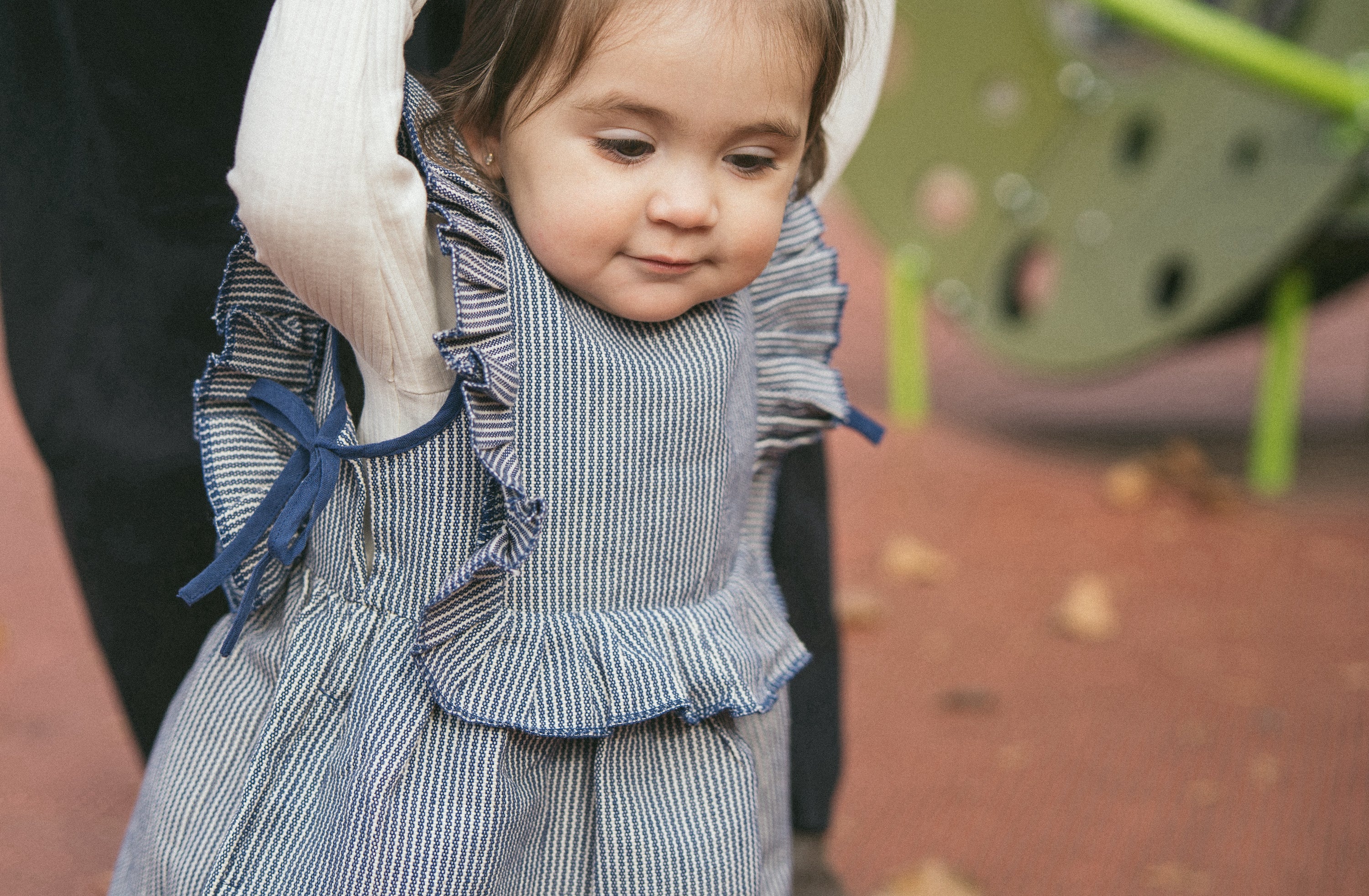 toddler wearing red wool vest and navy cotton stripe pants