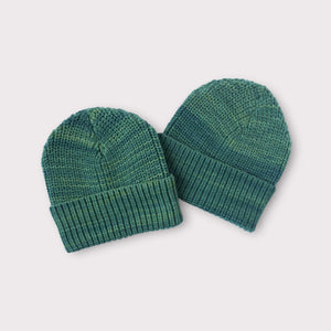 photo of two green knit beanie hats