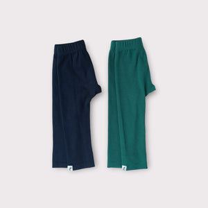 Green and navy leggings lying flat next to eachother
