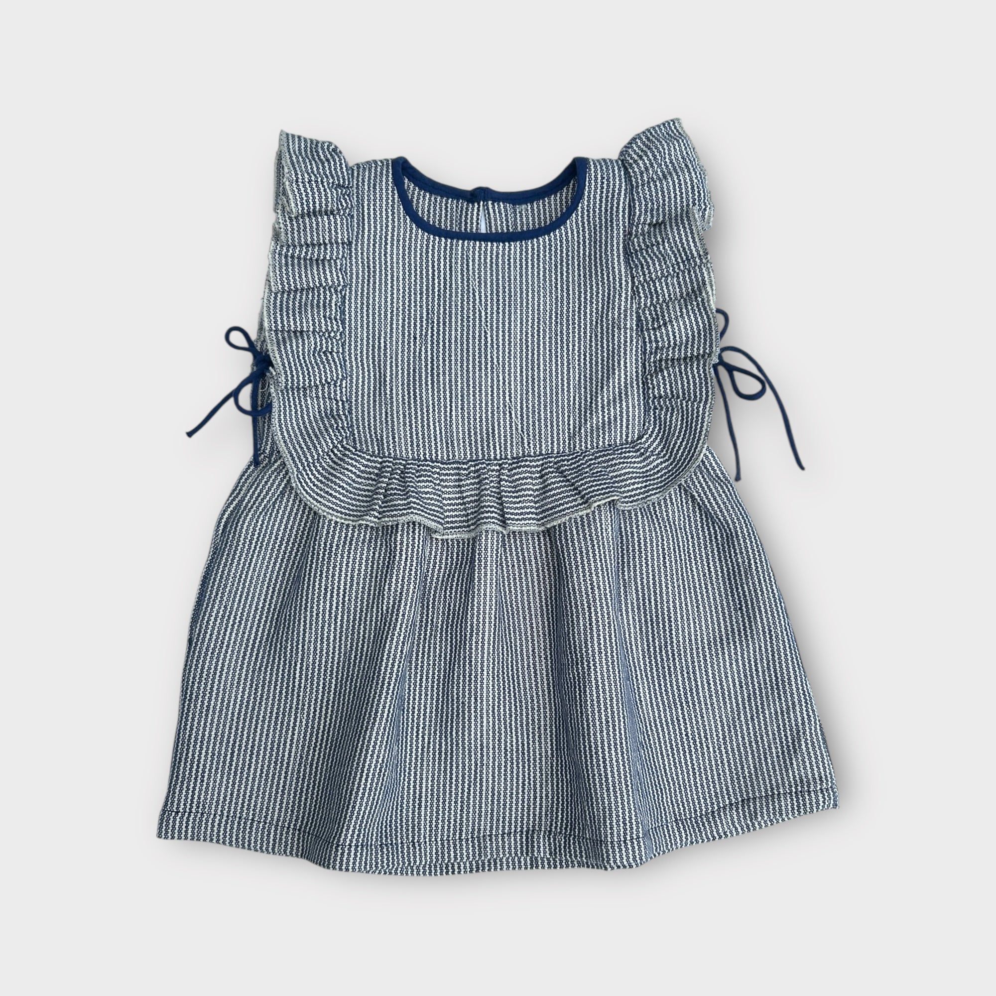 Blue and white striped dress with ruffled details on a white background