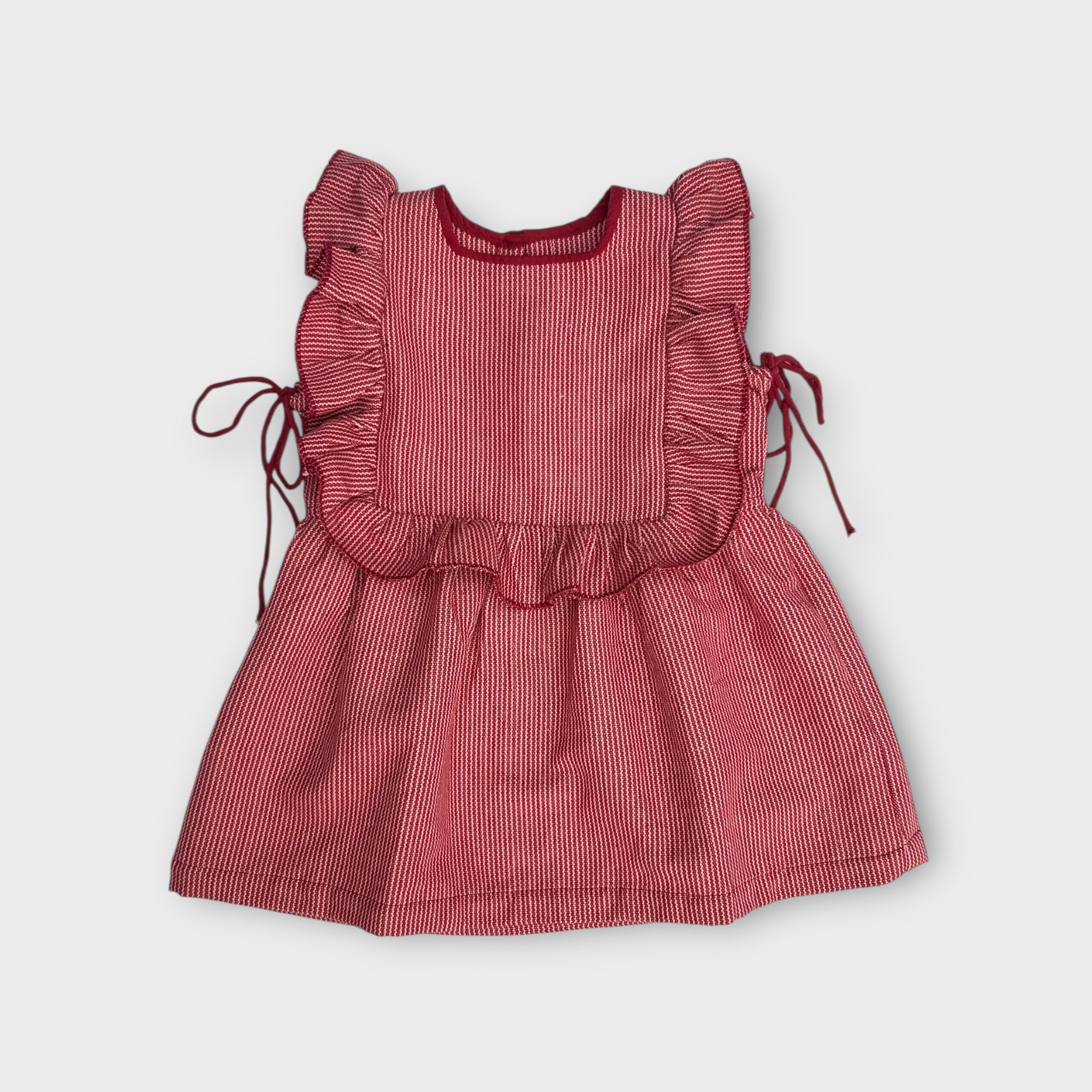 Red striped dress with ruffled details on a white background