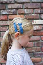 Load image into Gallery viewer, Girl wearing two blue sardine hair clips
