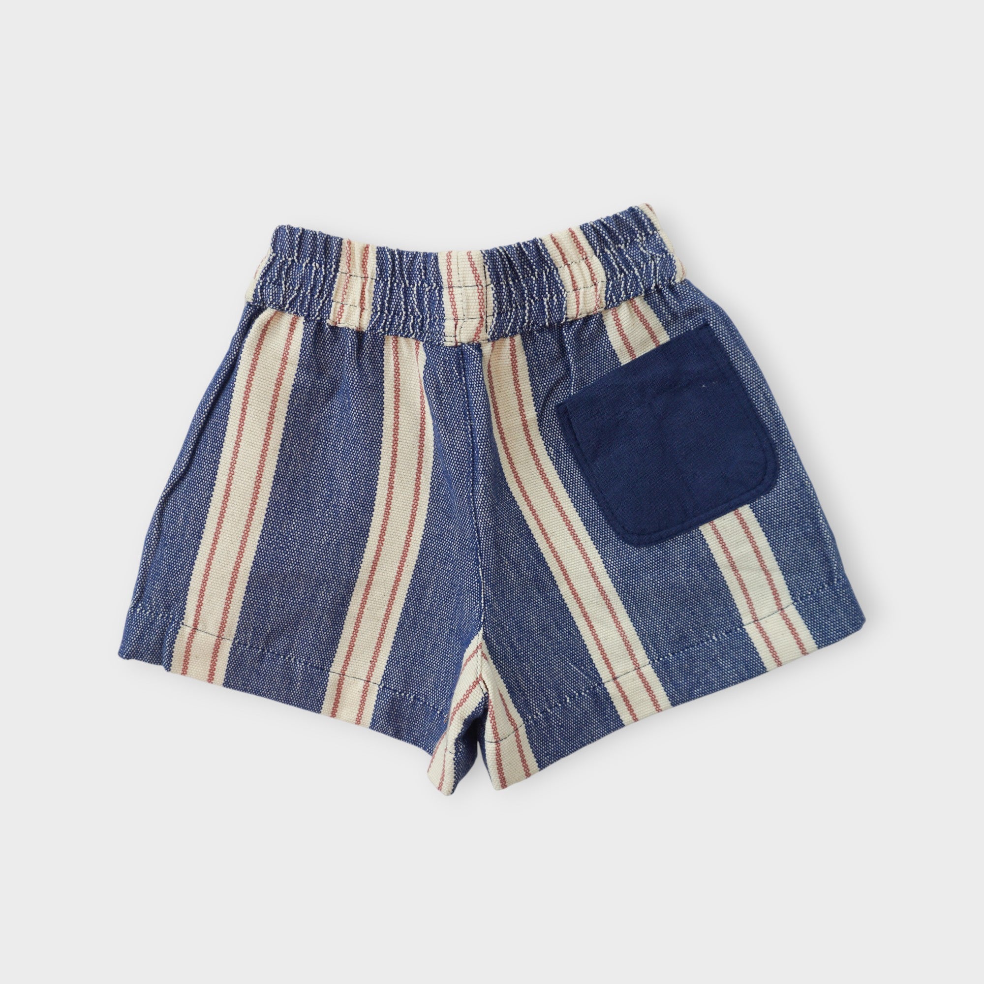 Organic cotton kids shorts in indigo blue umbrella stripe with elastic waistband, by League of Friends