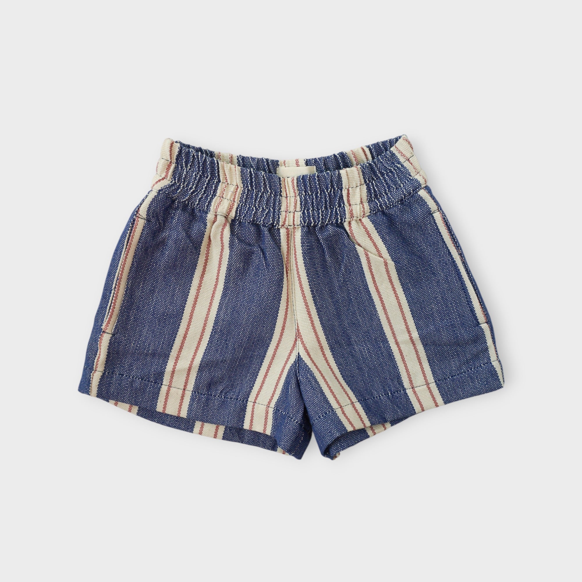 Organic cotton kids shorts in indigo blue umbrella stripe with elastic waistband, by League of Friends