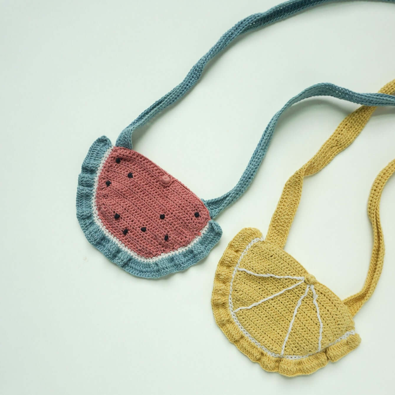 grouping of two crochet purses- watermelon and lemon